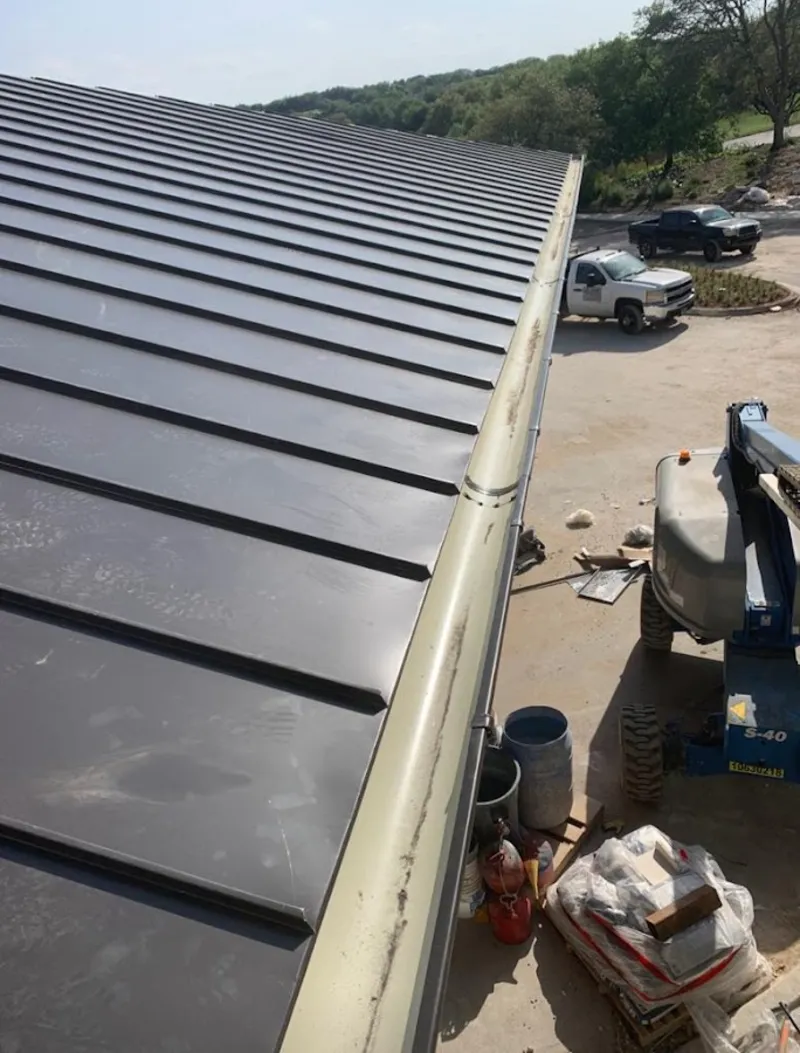 Standing seam panel and gutter detail on a metal roofing jobsite in Chatham